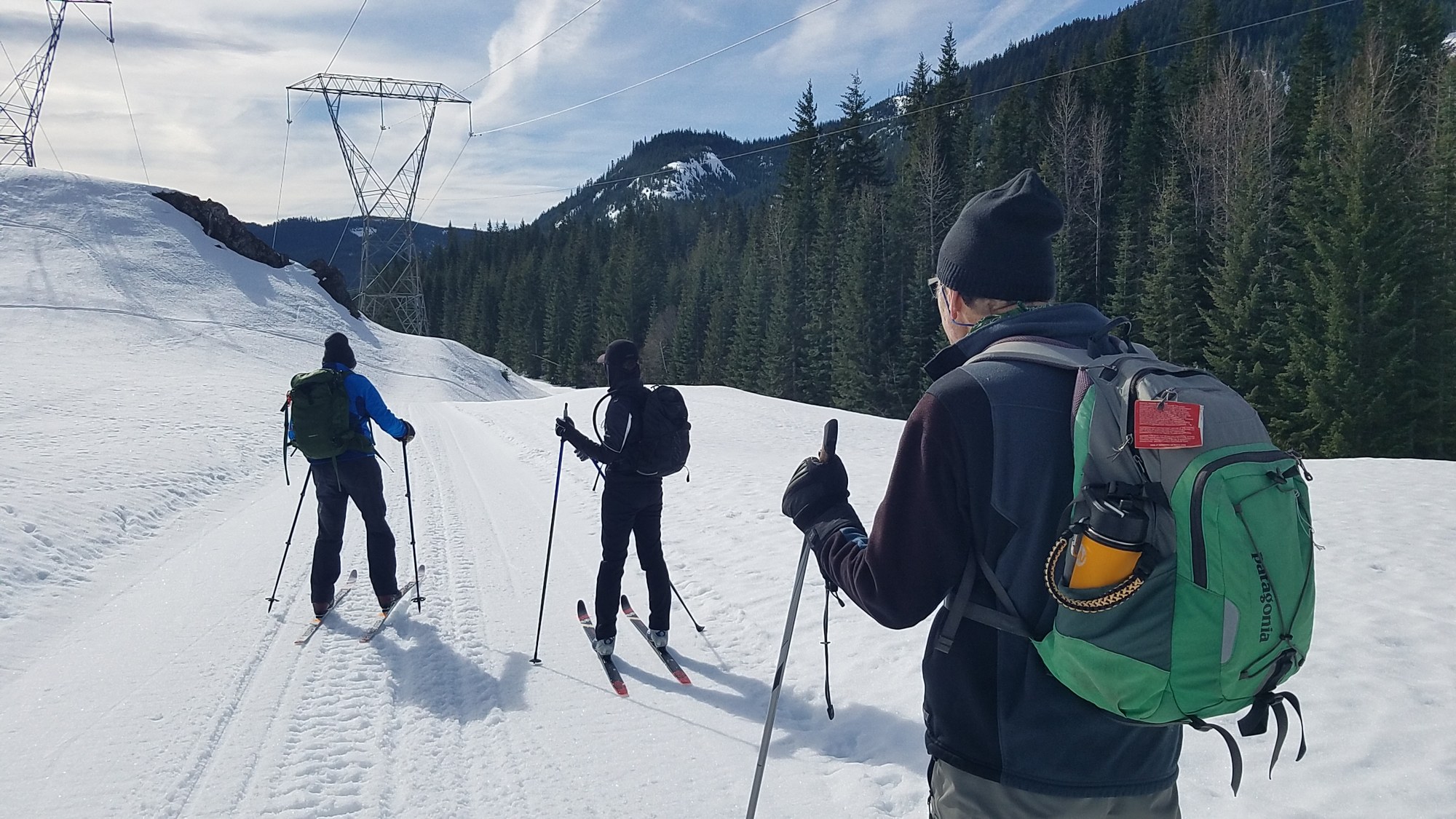Snowy White Alps And A Couple Of Ski Tourers Climbing Up The Mountain