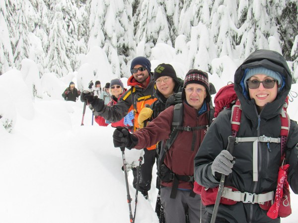 A grup of people snowshoeing.