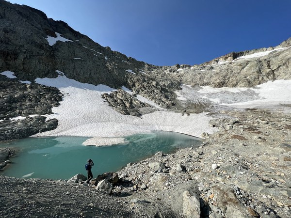 A typical pose of Frank! Hyas Creek Glacier that once carved the terrain with alpine tarn in front 