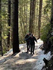 Two hikers on a snowy trail
