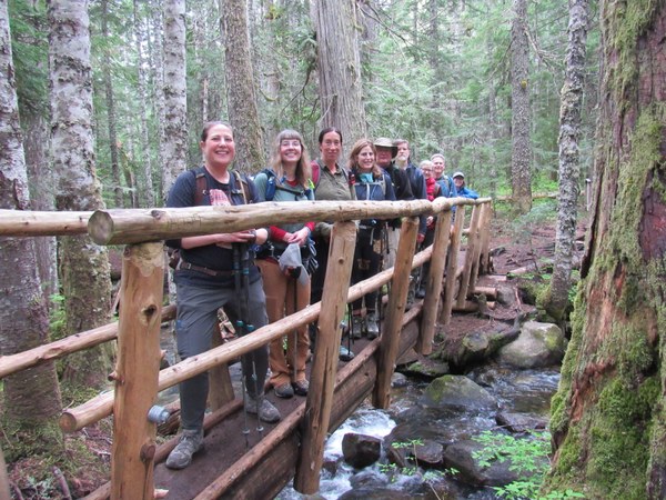 A group of hikers standing on a bridge.