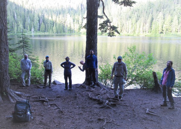 six hikers by a lake