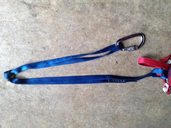 overhand or a figure-8 knot at the midpoint of the sling