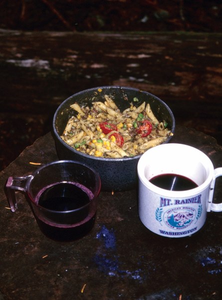 An overflowing pot of pesto pasta with smoked salmon and cabernet.jpg