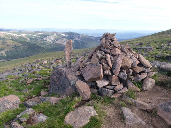 Rock cairn with mountains in background